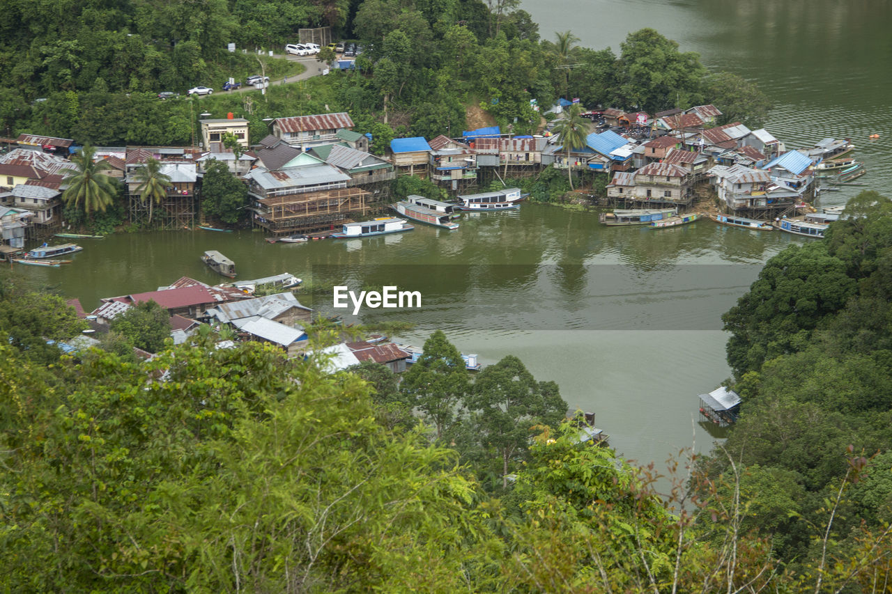 High angle view of houses by lake and buildings