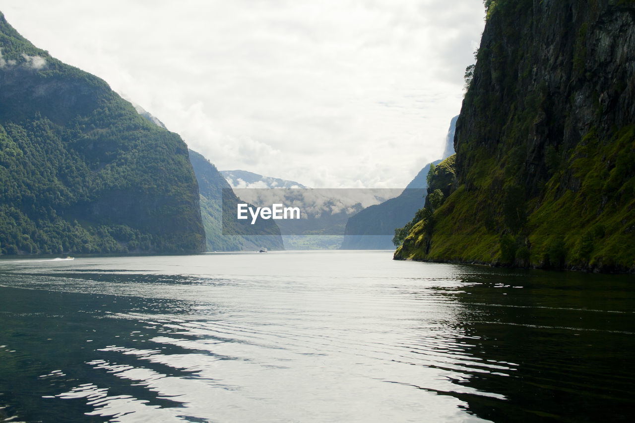 Scenic view of lake and mountains against sky