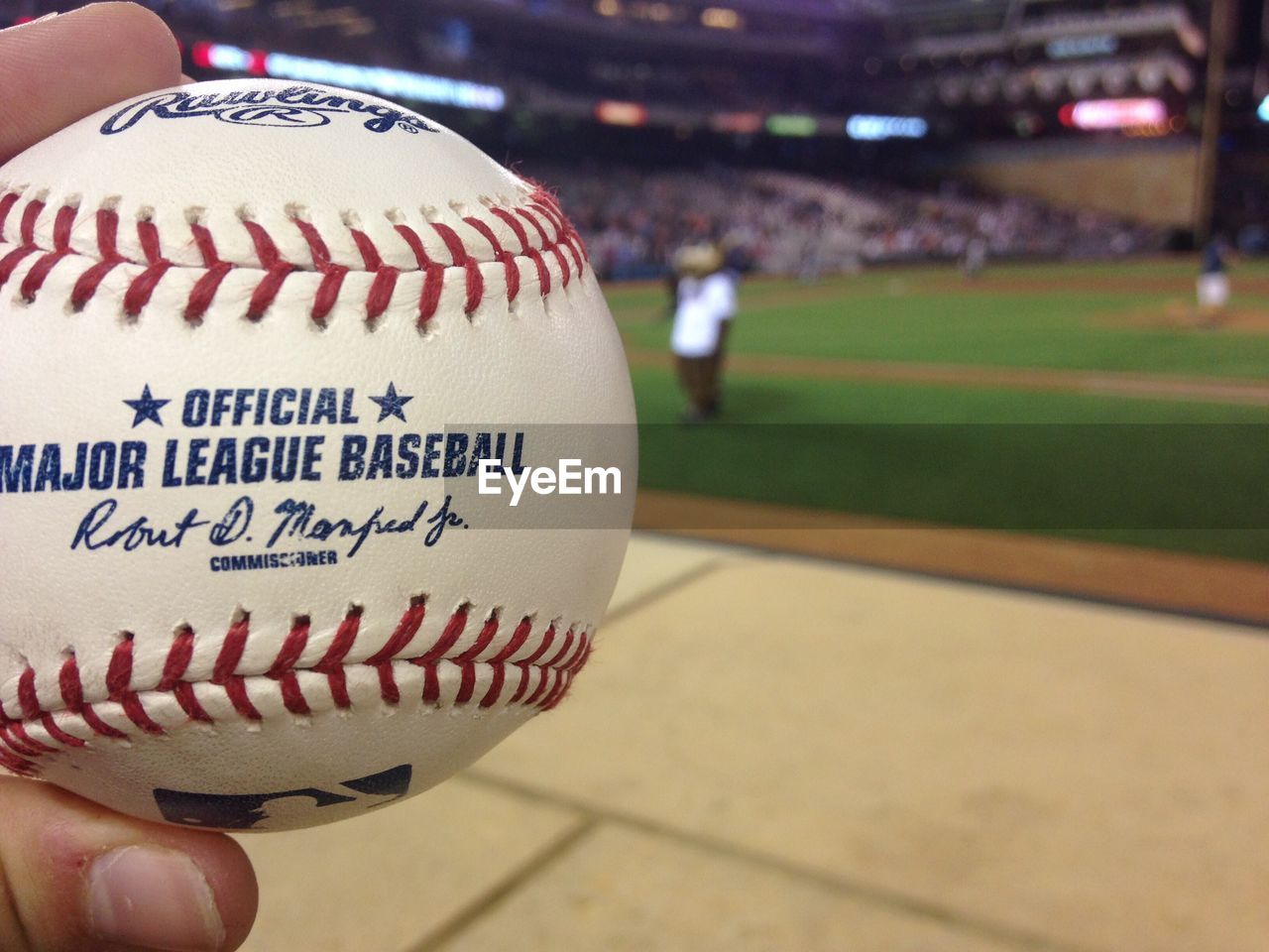 CLOSE-UP OF MAN HAND HOLDING BALL WITH UMBRELLA