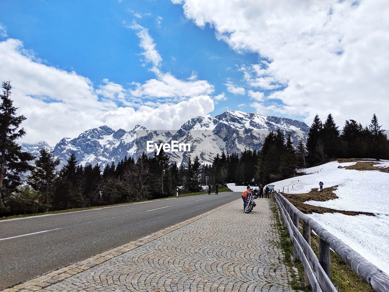 REAR VIEW OF PEOPLE WALKING ON SNOWCAPPED MOUNTAIN AGAINST SKY