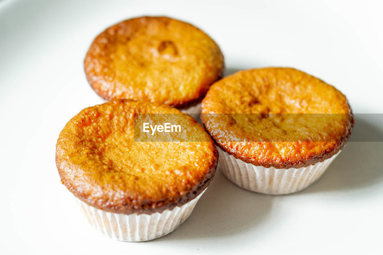 food and drink, food, sweet food, sweet, dessert, baked, cupcake, cake, produce, freshness, muffin, white background, indoors, no people, studio shot, close-up, unhealthy eating, temptation, fruit, snack, citrus, baked pastry item, cut out, group of objects