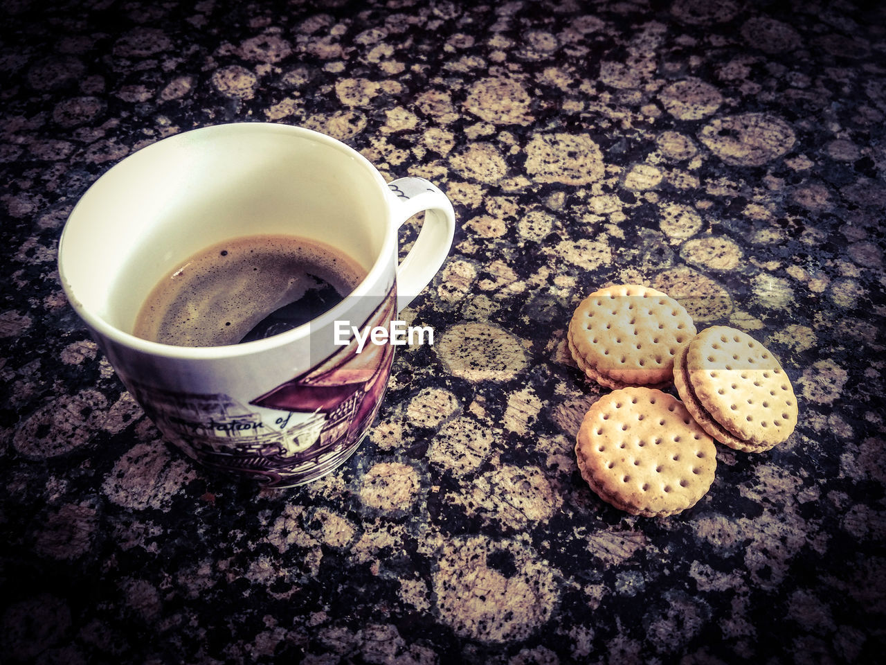 HIGH ANGLE VIEW OF COFFEE CUP ON COOKIES