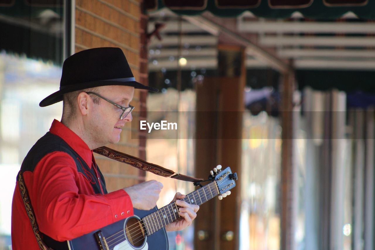 Musician playing guitar in restaurant