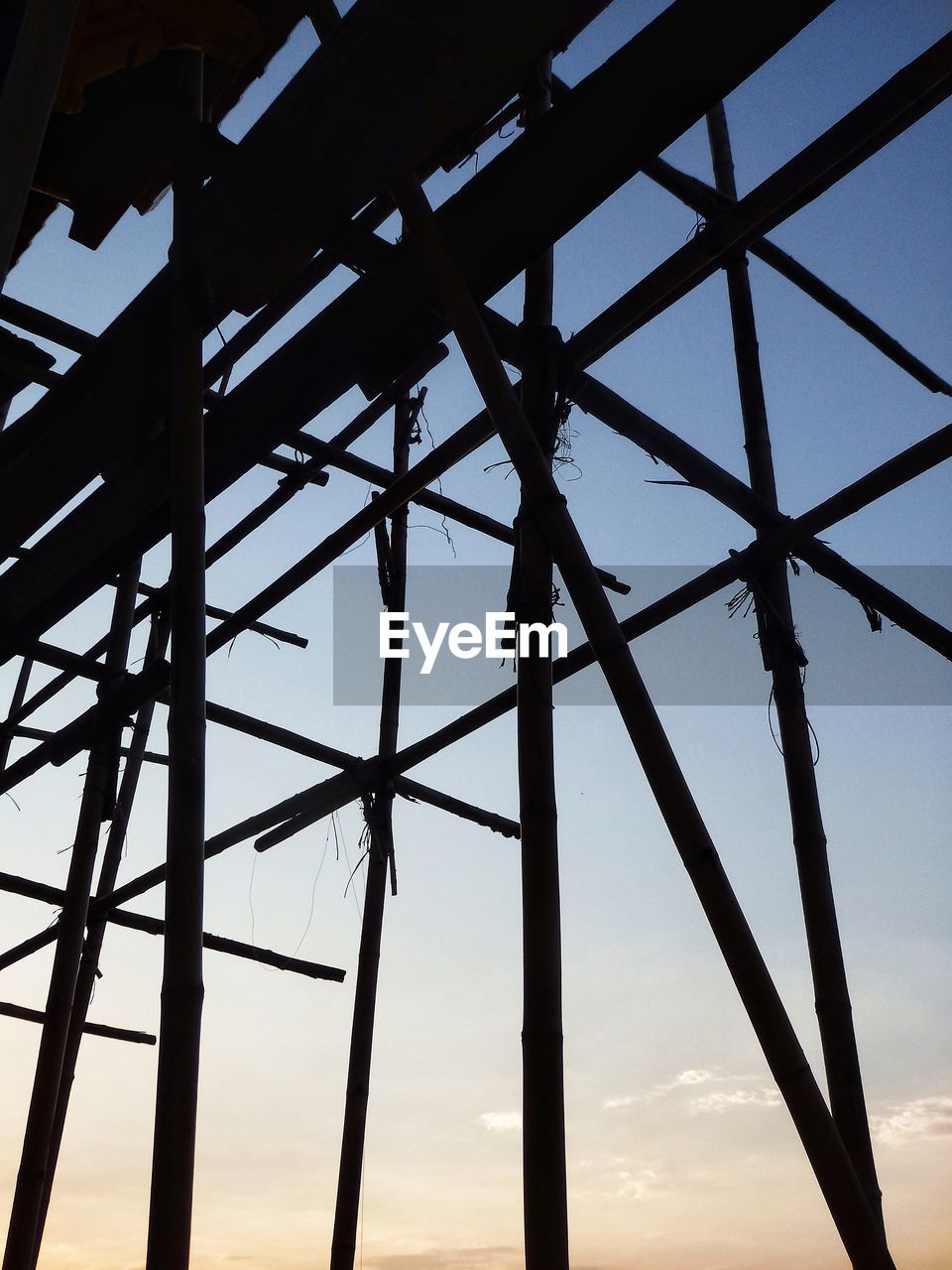 sky, architecture, silhouette, sunset, built structure, nature, no people, line, power generation, cloud, technology, industry, outdoors, electricity, low angle view, metal, environment, blue, sunlight, girder, electricity pylon, power supply, alloy, business finance and industry, dusk
