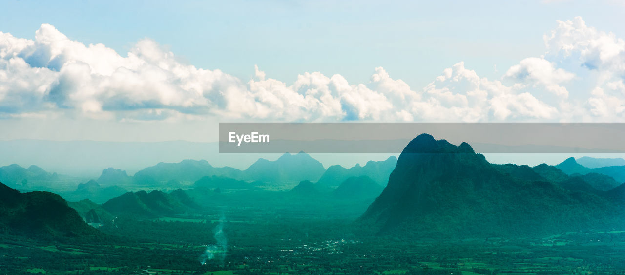 PANORAMIC VIEW OF LAND AND MOUNTAINS AGAINST SKY