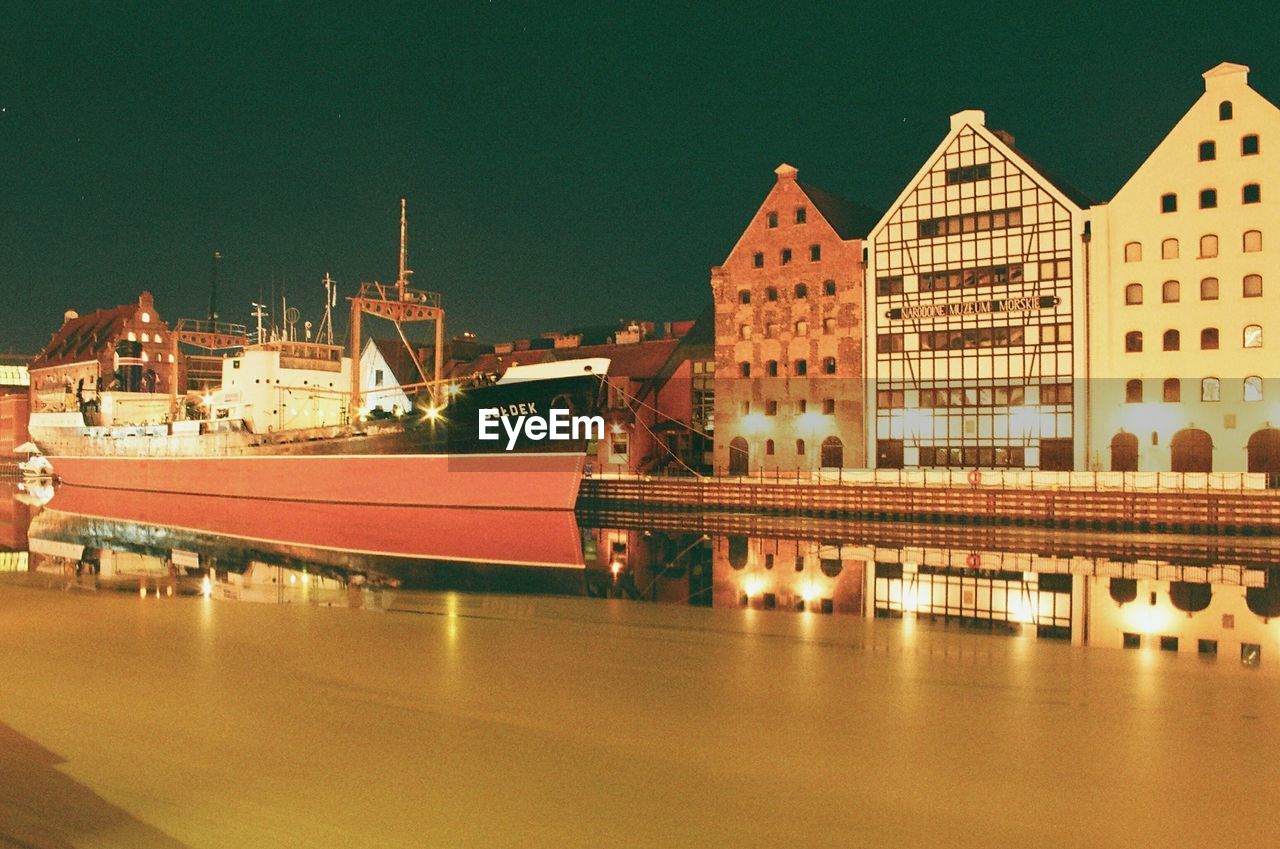 REFLECTION OF ILLUMINATED BUILDINGS AT HARBOR