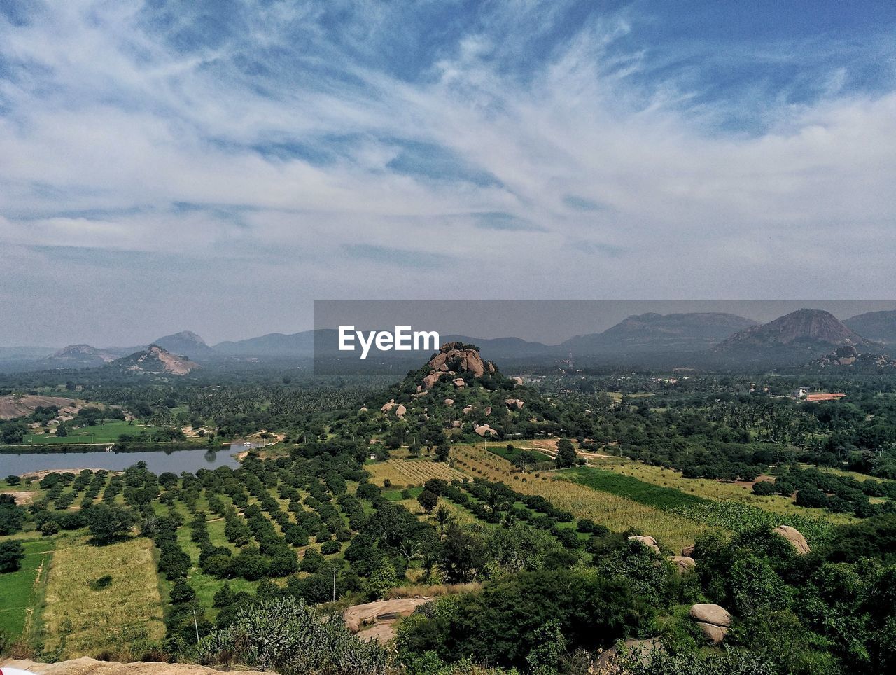 AERIAL VIEW OF AGRICULTURAL FIELD AGAINST SKY