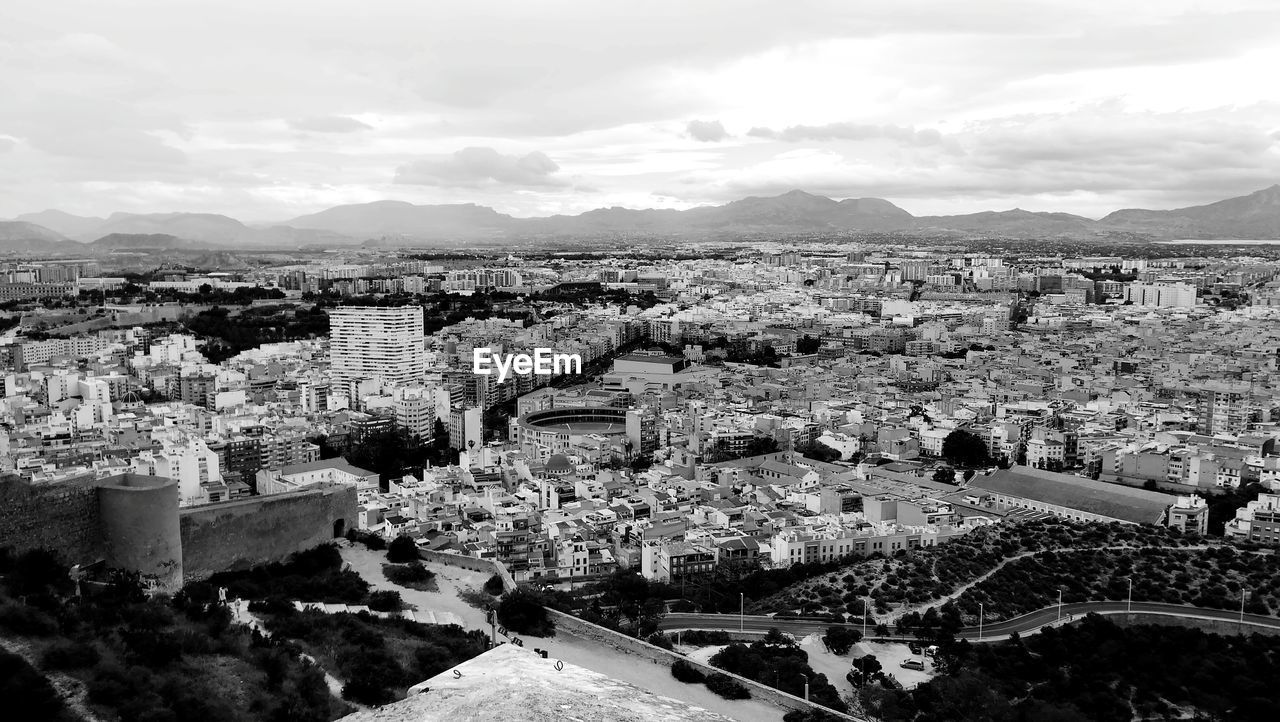 HIGH ANGLE VIEW OF TOWN AGAINST SKY