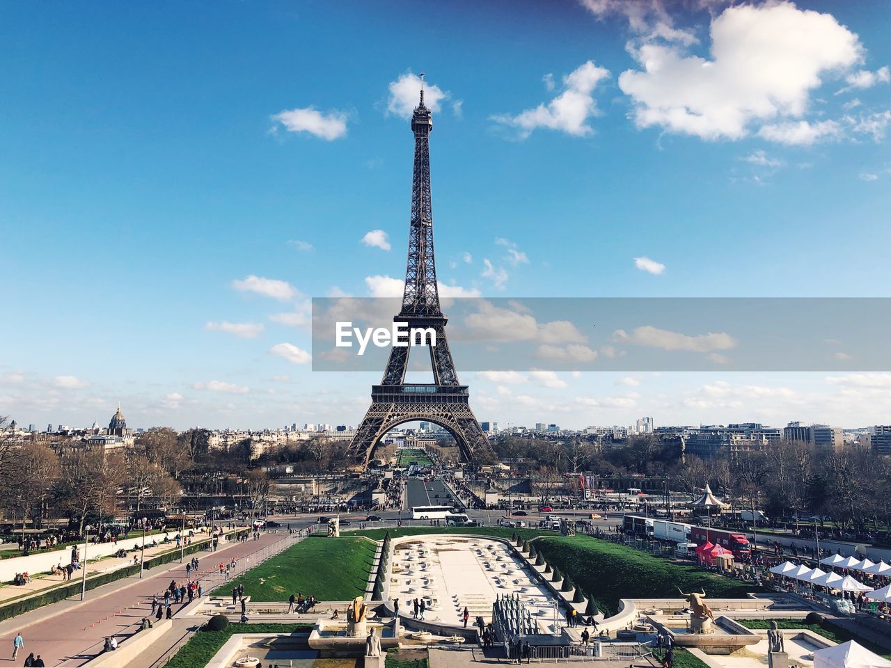 Eiffel tower against cloudy sky