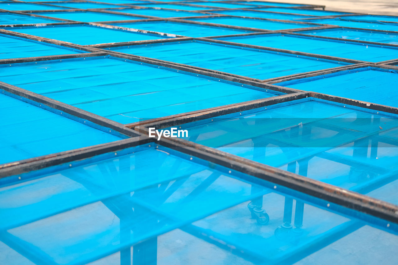 FULL FRAME SHOT OF SWIMMING POOL WITH REFLECTION IN WATER
