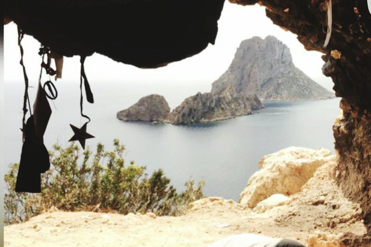 SCENIC VIEW OF MOUNTAIN BY SEA