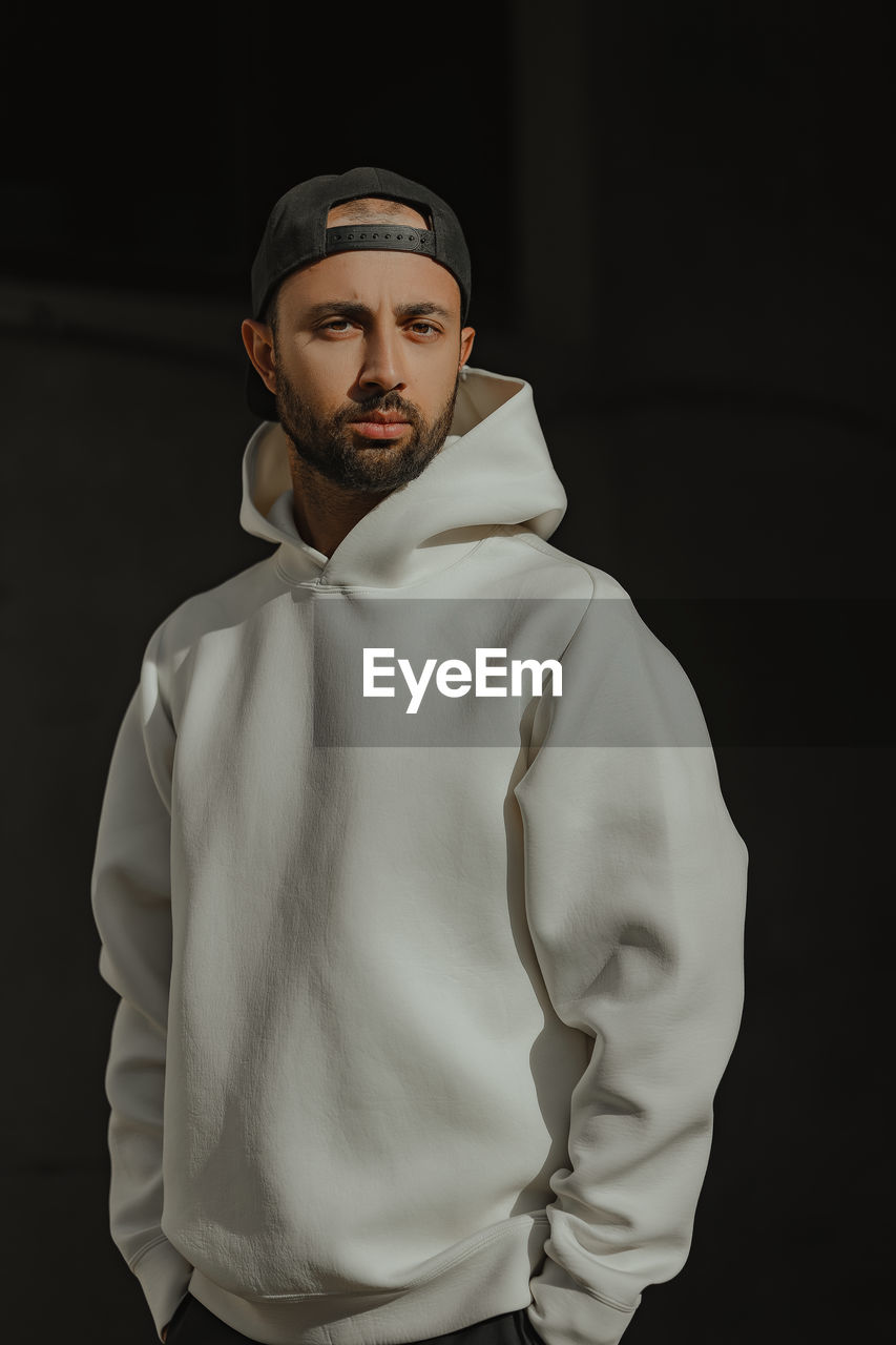 Portrait of a man in a white hoodie
