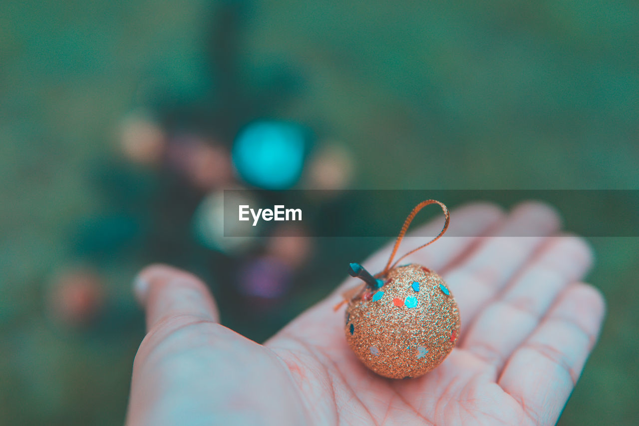 Close-up of hand holding christmas decoration