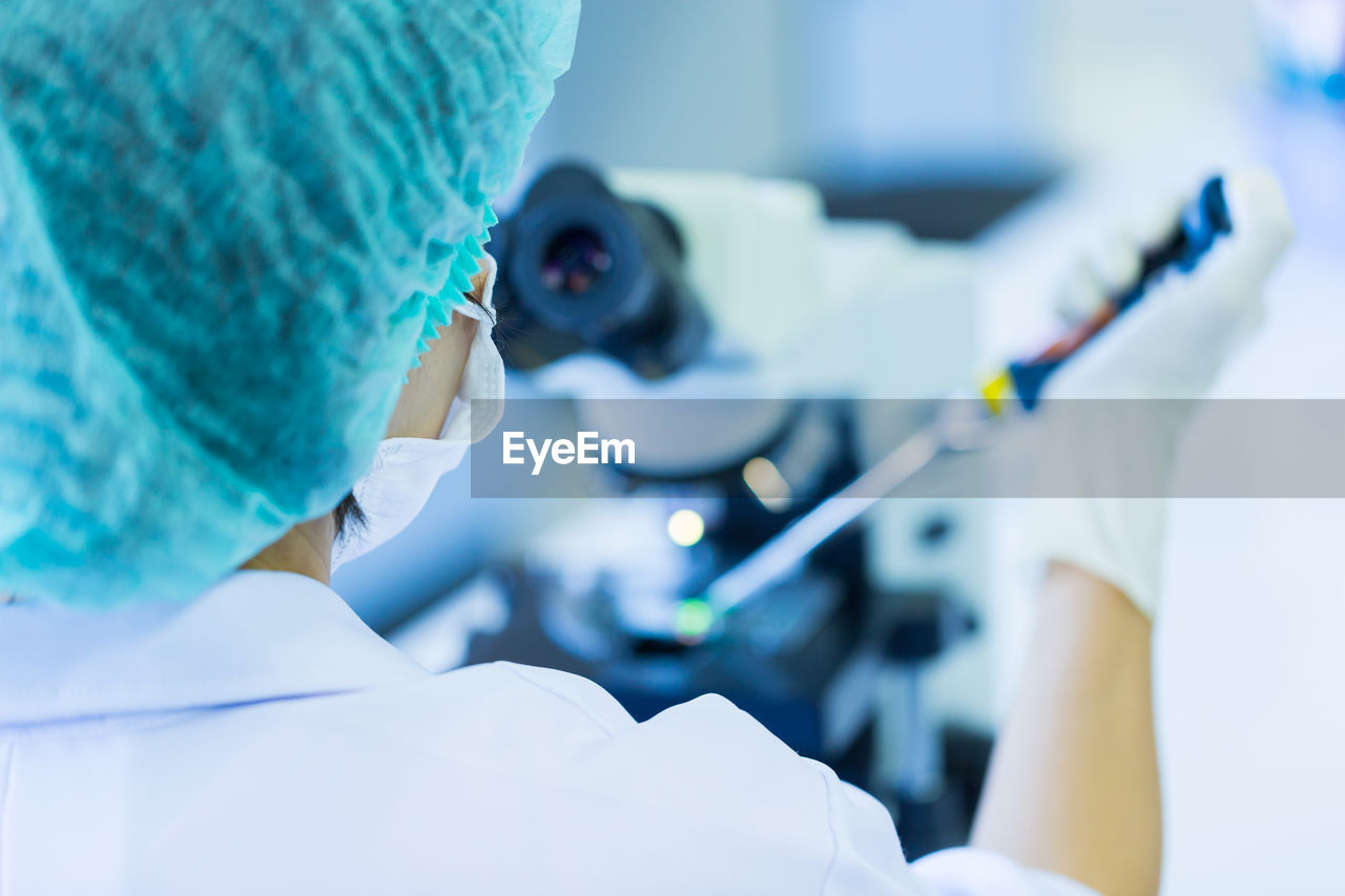 Rear view of woman working in laboratory