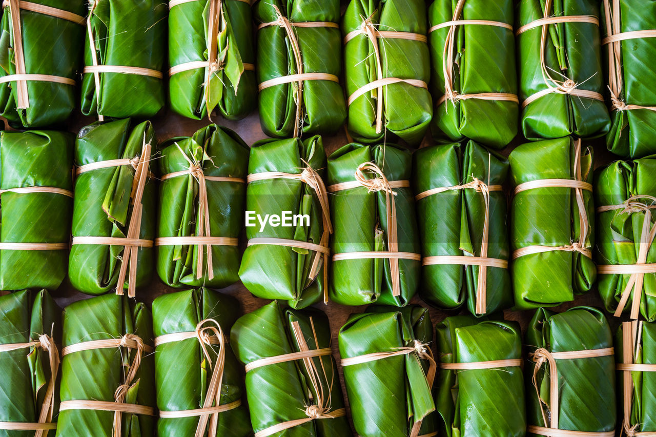 Full frame shot of food wrapped in banana leaves for sale at market stall