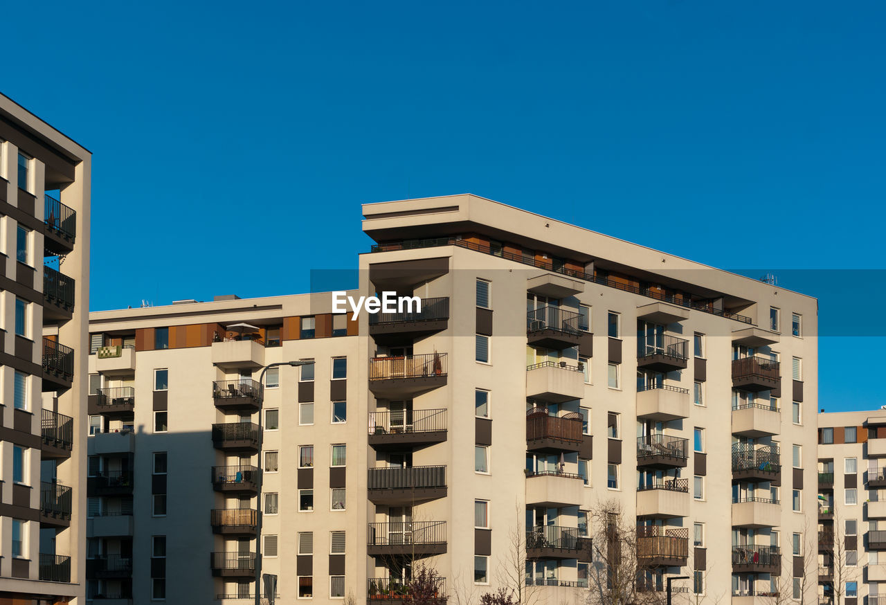 Low angle view of buildings against clear blue sky