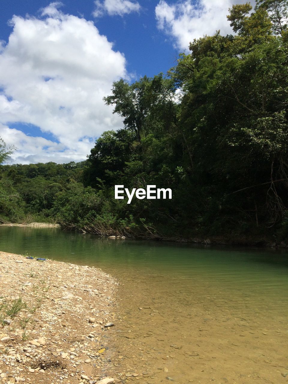 SCENIC VIEW OF LANDSCAPE BY LAKE AGAINST SKY