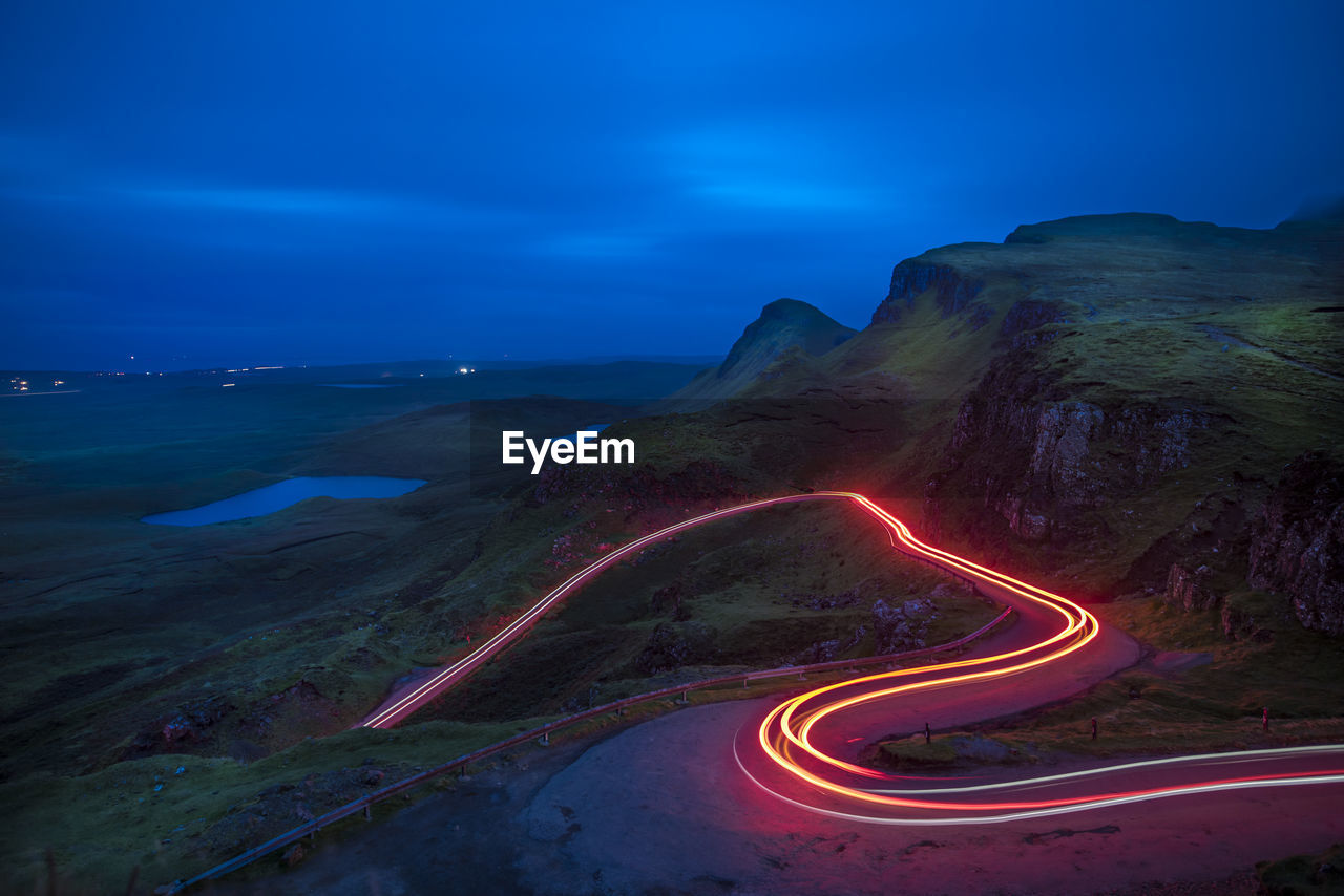 High angle view of light trails on road against sky at night