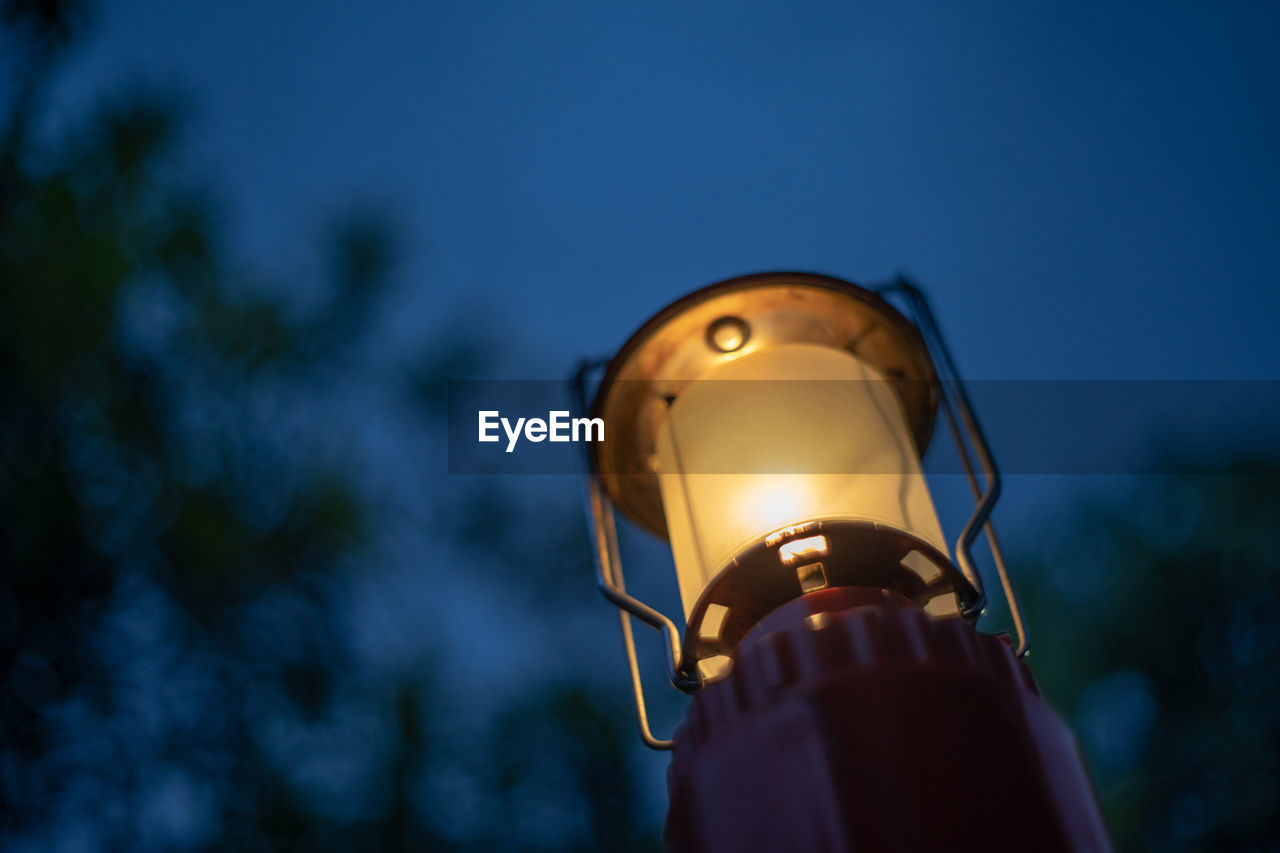 LOW ANGLE VIEW OF ILLUMINATED LAMP AGAINST SKY