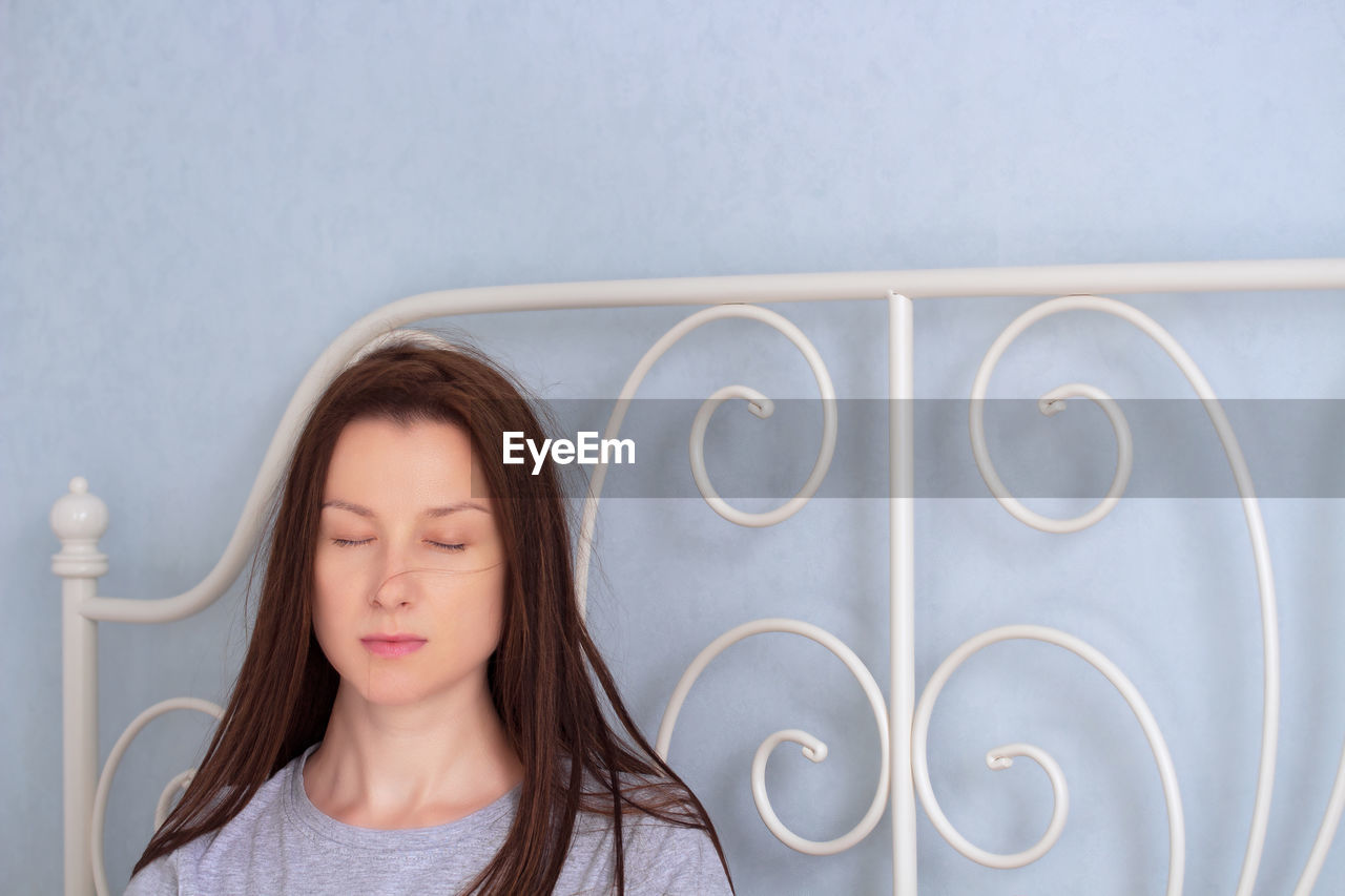 Portrait of young woman with closed eyes at home. lockdown authenticity