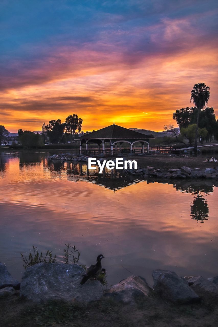 Scenic view of lake against orange sky