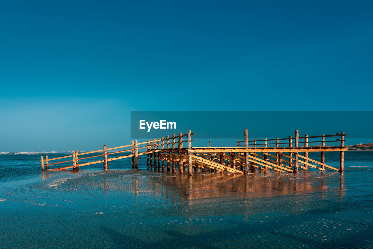 Pile dwelling on the norsee beach of sankt peter-ording in germany