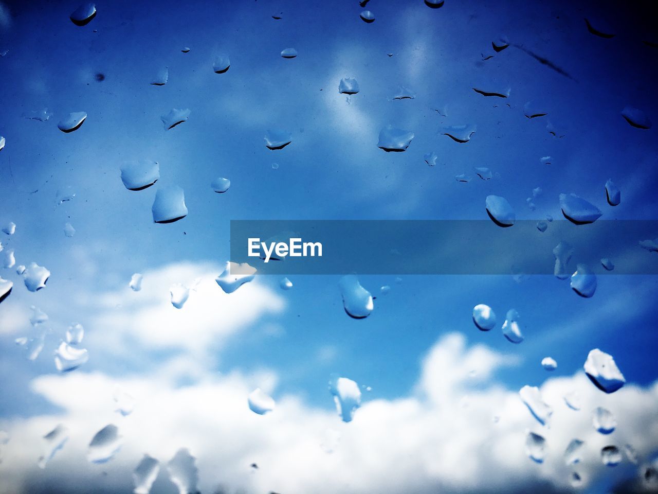 Cloudy sky seen through wet glass during monsoon