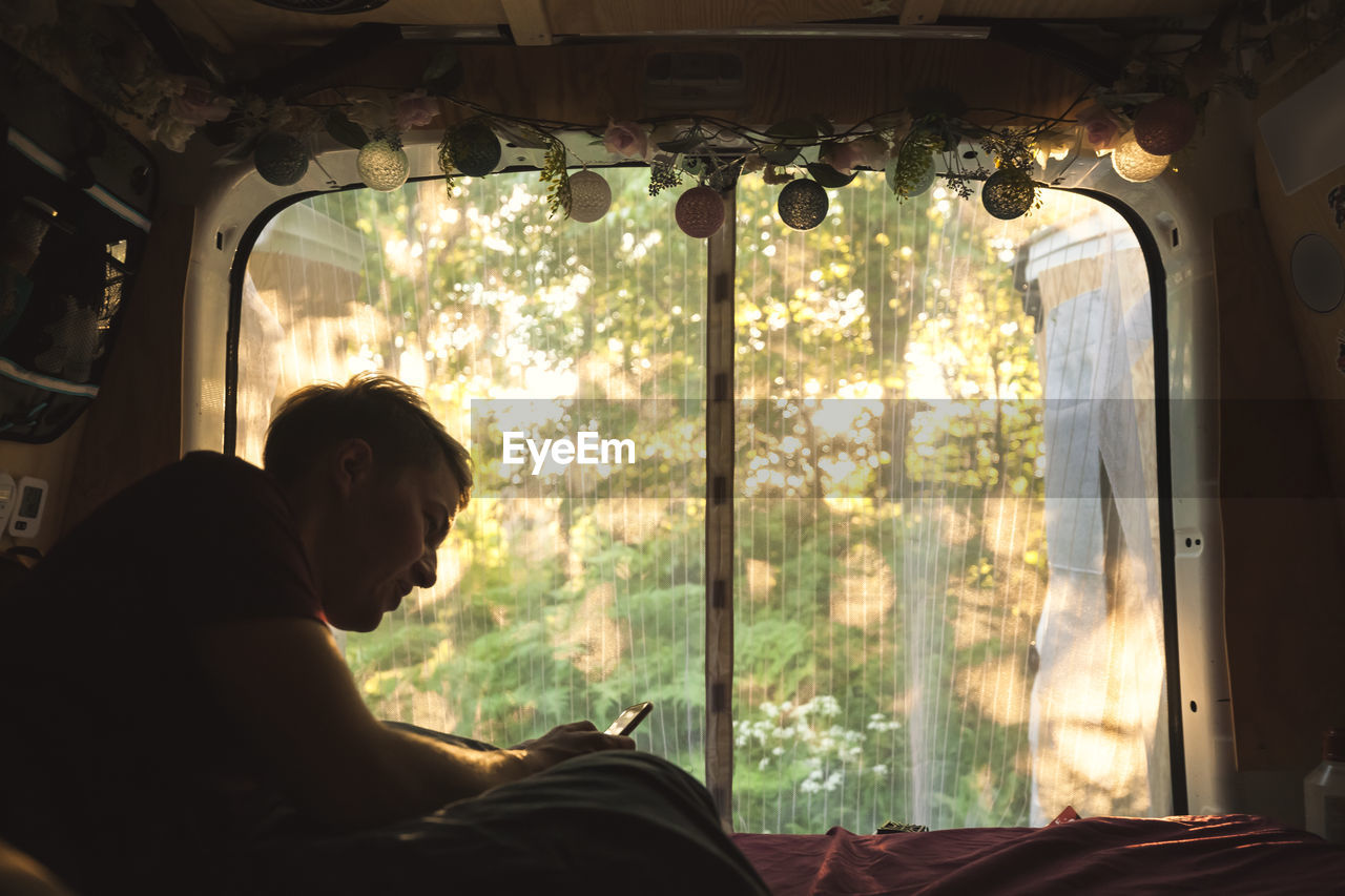 Young man resting in camper van