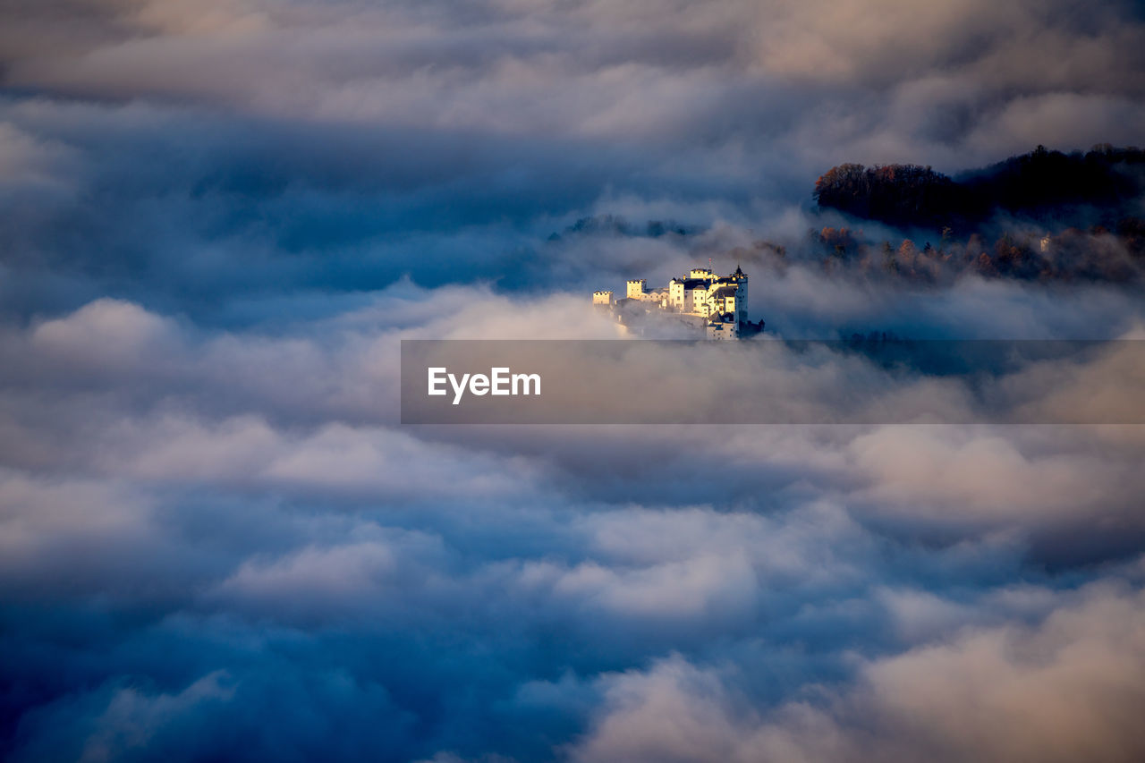 Fortress hohensalzburg rising above a sea of clouds, salzburg, austria