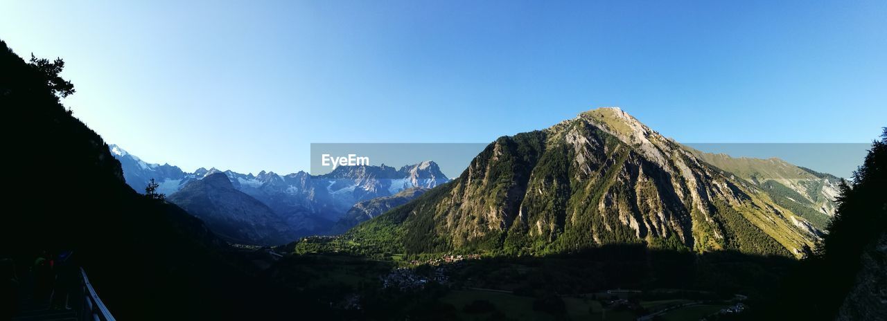 PANORAMIC VIEW OF MOUNTAIN RANGE AGAINST CLEAR SKY