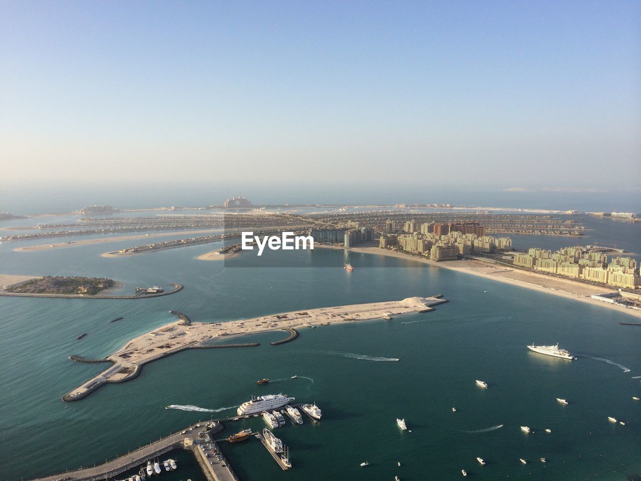 Aerial view of city and sea against clear sky