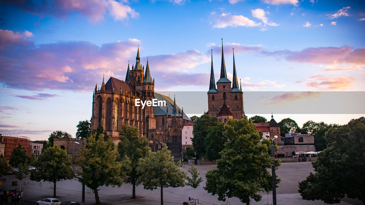 Panoramic view of buildings and trees against sky in city