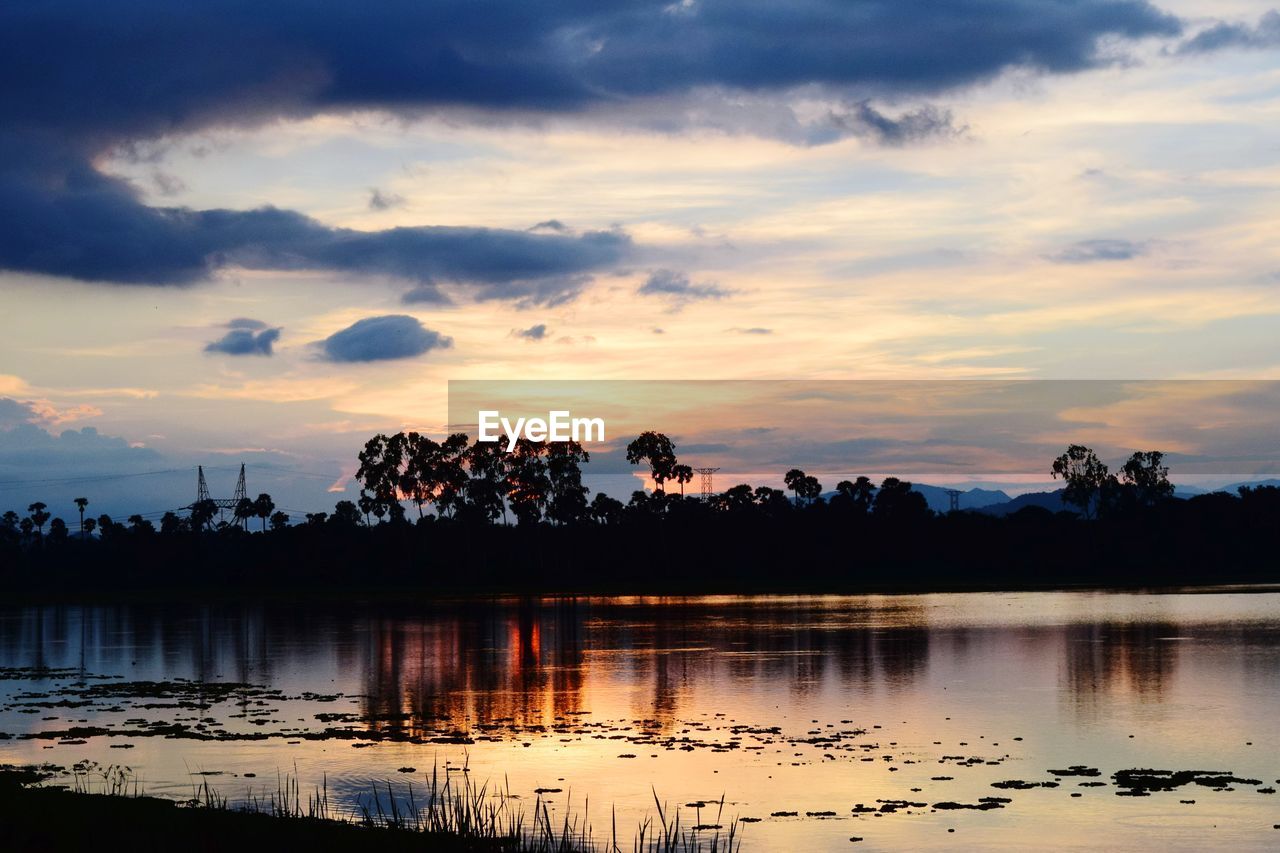 SCENIC VIEW OF LAKE AGAINST ORANGE SKY
