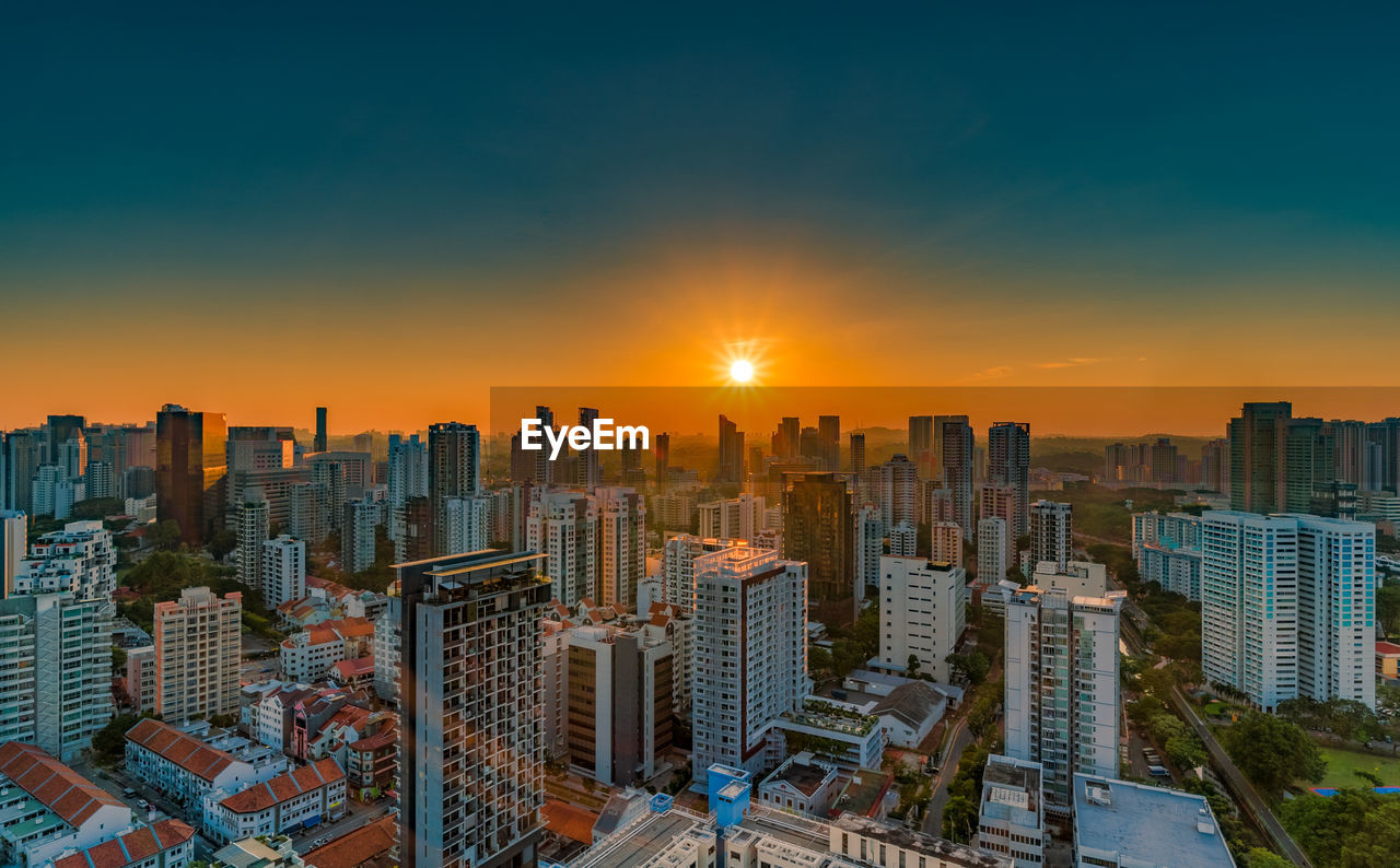 MODERN BUILDINGS AGAINST SKY DURING SUNSET