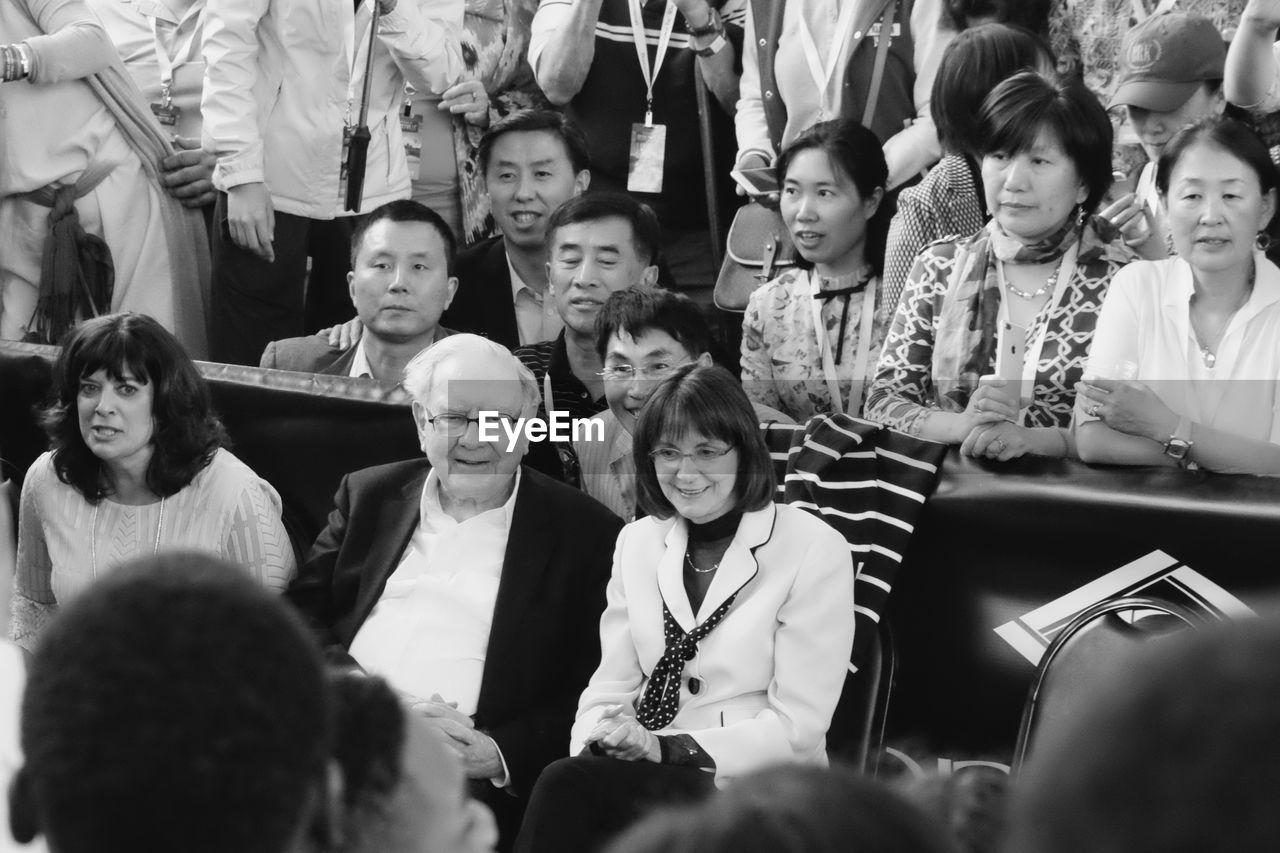 HIGH ANGLE VIEW OF PEOPLE SITTING IN CLASSROOM