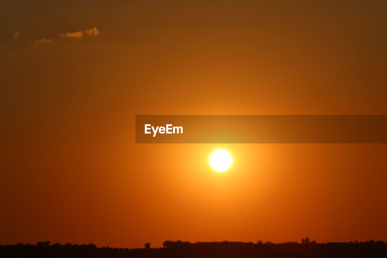 SCENIC VIEW OF SUNSET OVER LANDSCAPE