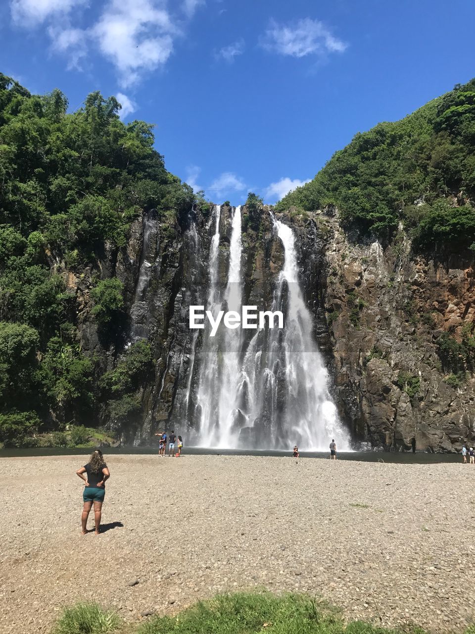 Scenic view of waterfall against sky