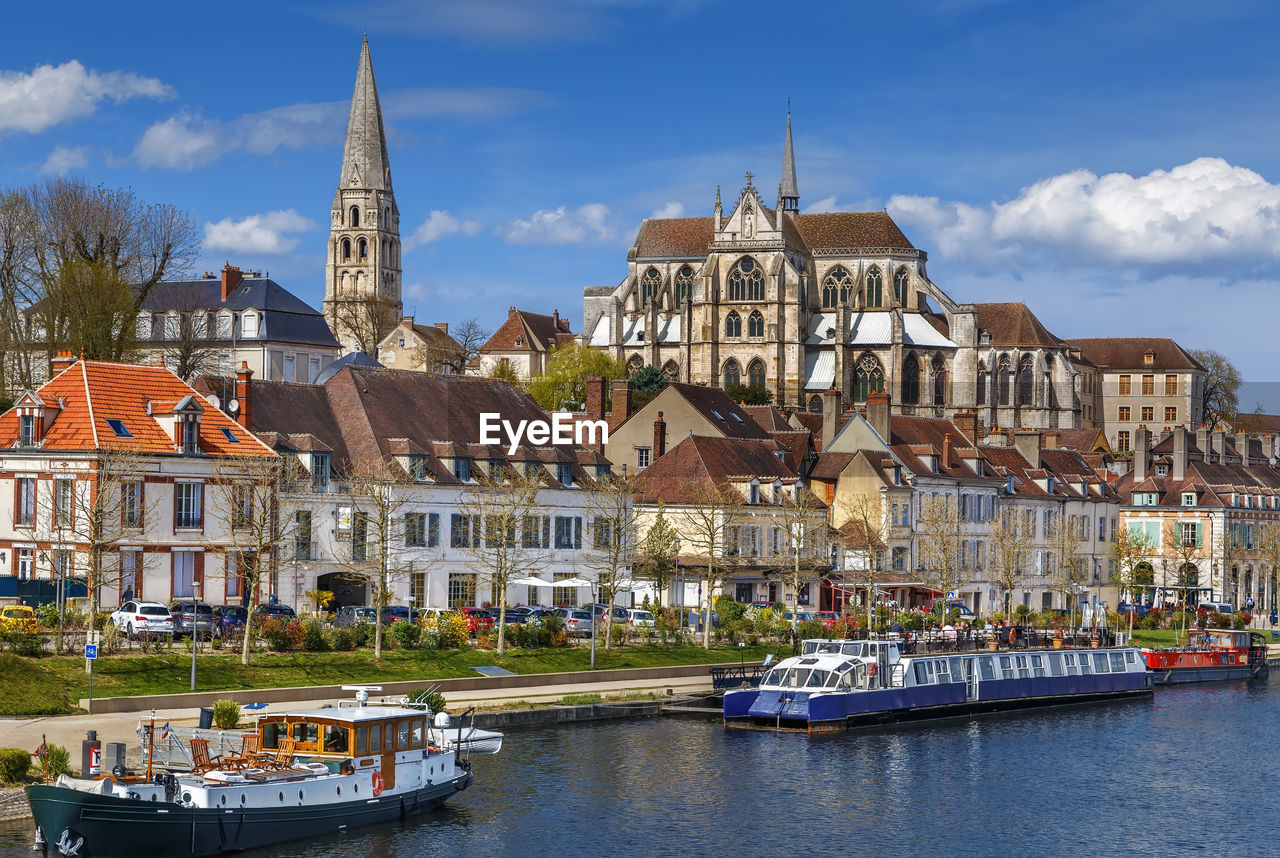 BOATS IN RIVER AGAINST BUILDINGS