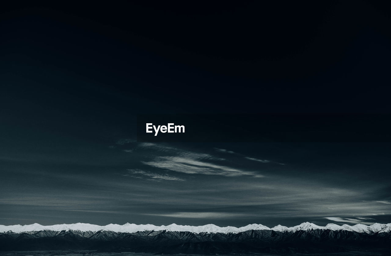 Scenic view of snowy field against sky at night