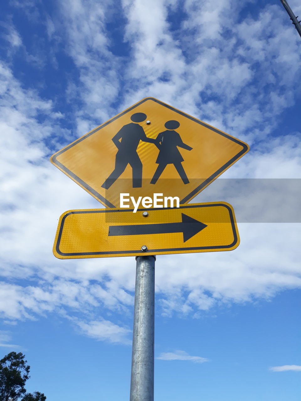 Low angle view of road sign against sky