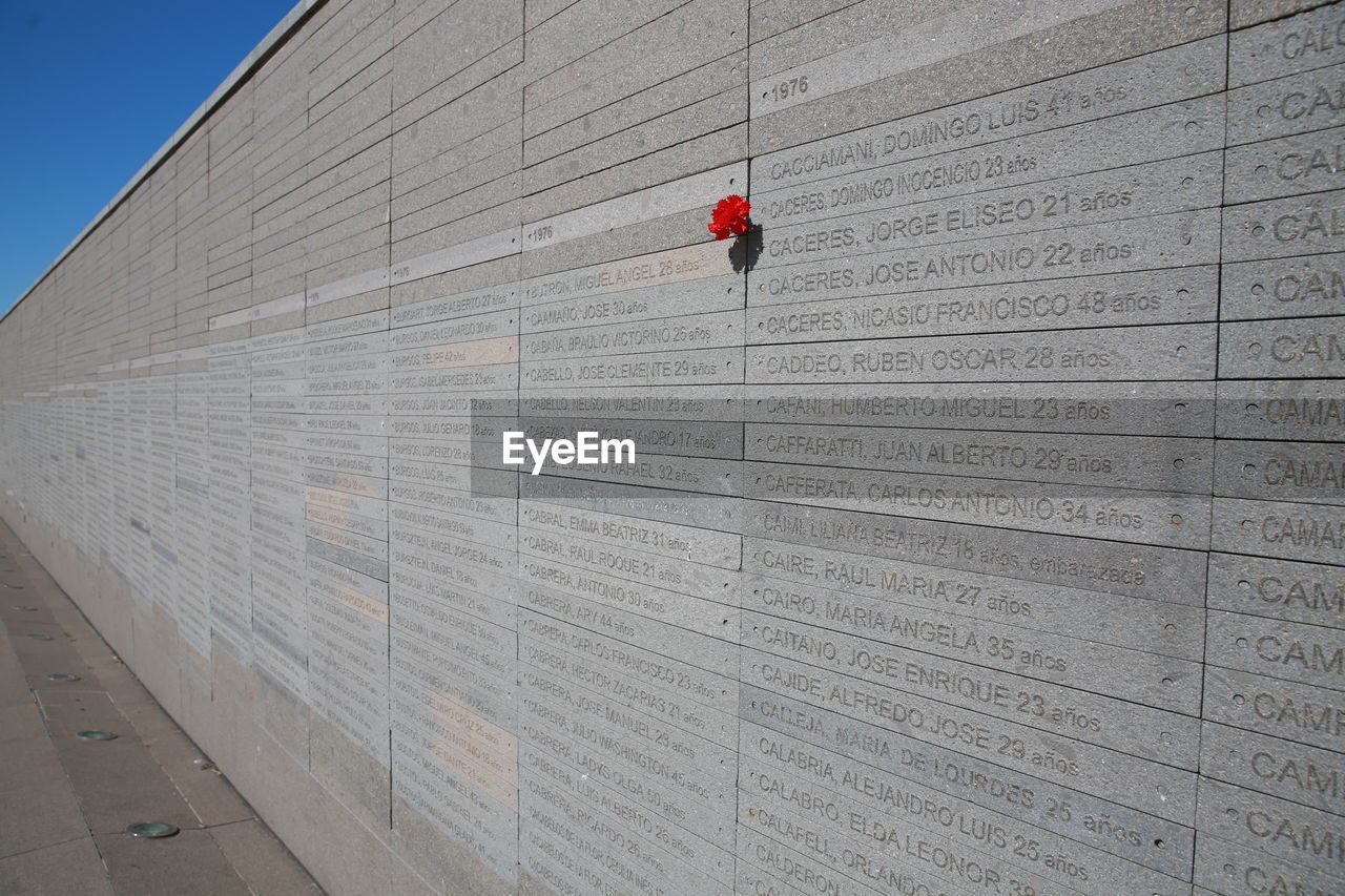 wall, architecture, one person, wood, built structure, wall - building feature, day, line, building exterior, red, outdoors, nature, sky, roof, full length, sports, adult, city, lifestyles, men, floor