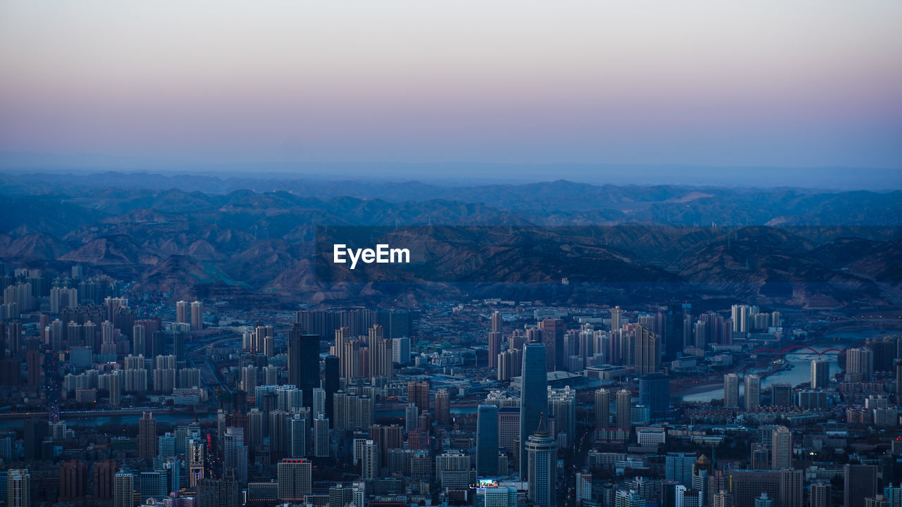 High angle view of city buildings against sky