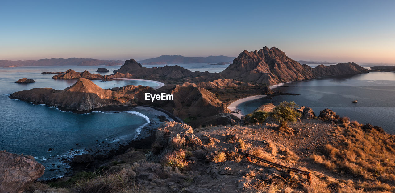 Scenic view of sea and mountains against sky during sunset