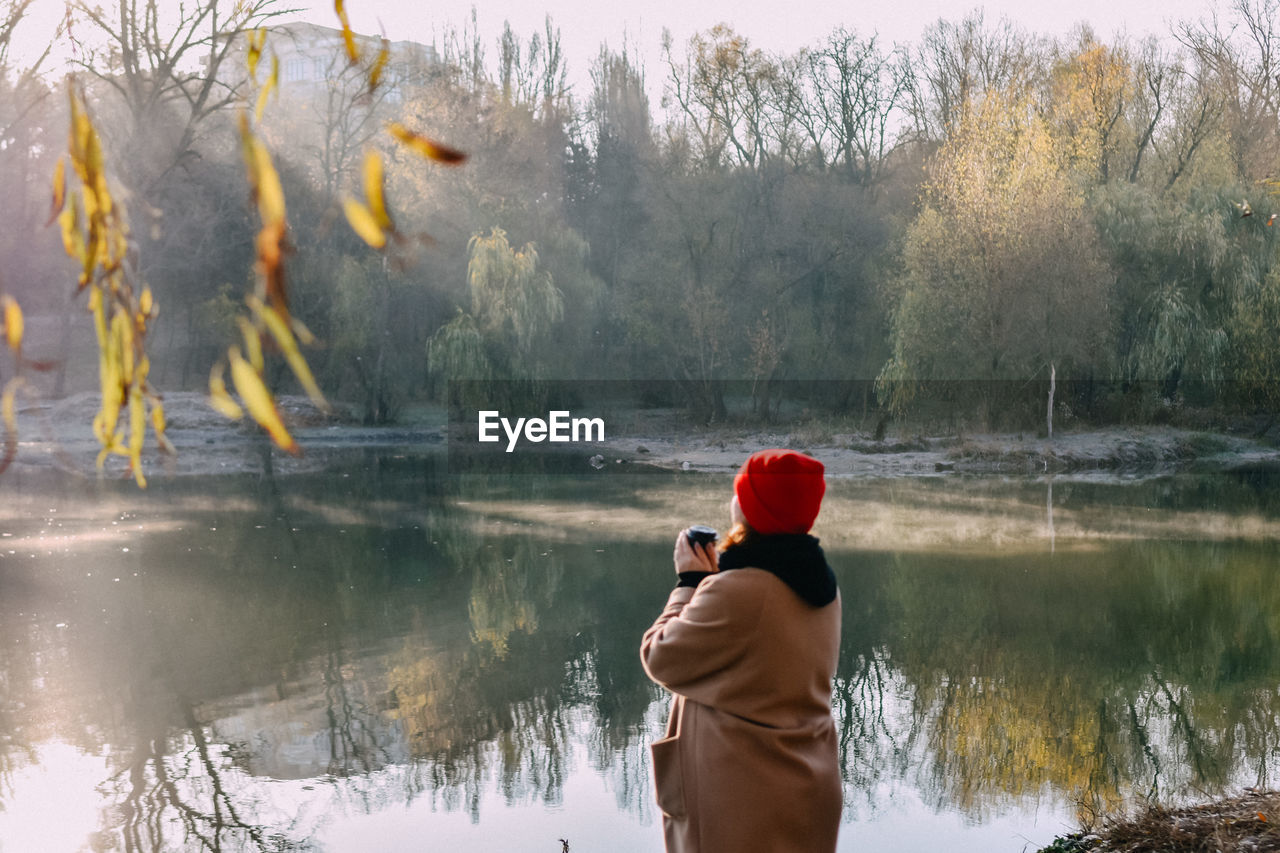 Rear view of man standing in lake