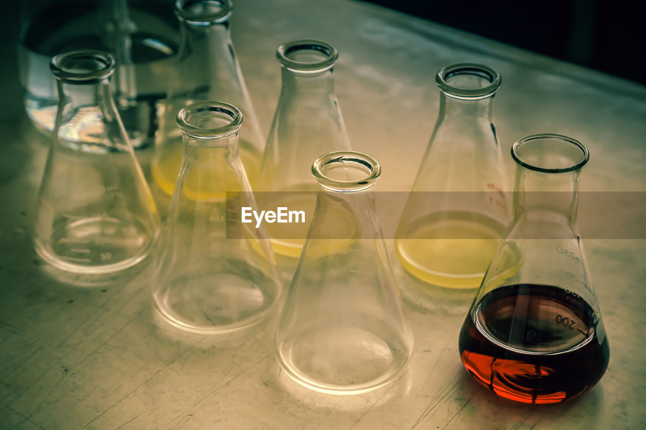 Close-up of liquids in beakers on table 