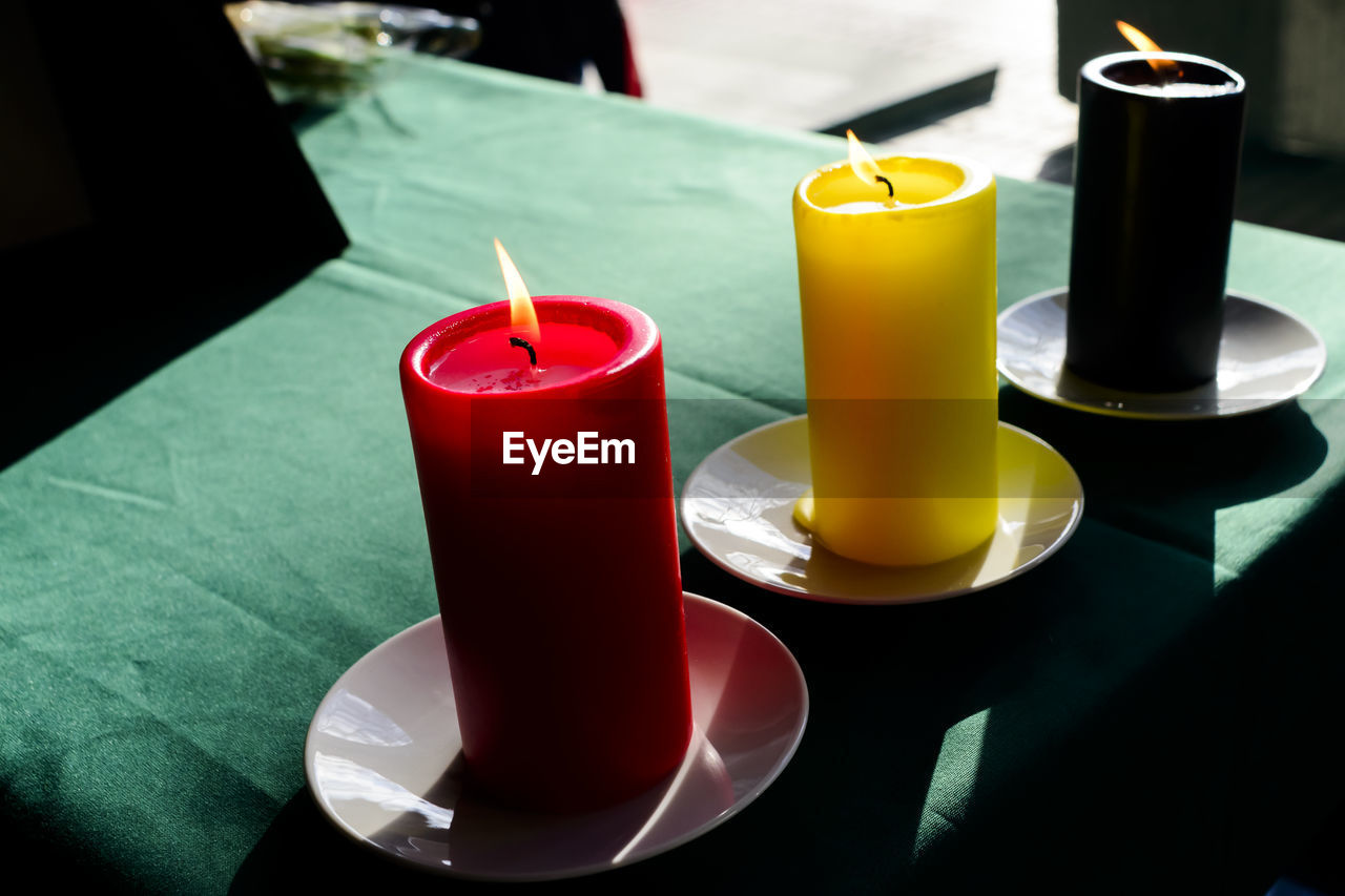 View of candles burning on table