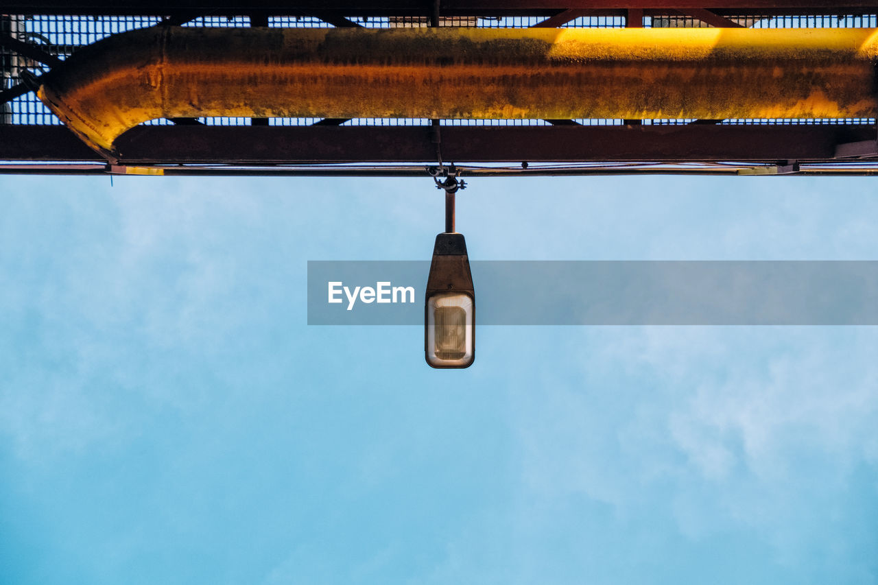 Low angle view of illuminated street light against sky