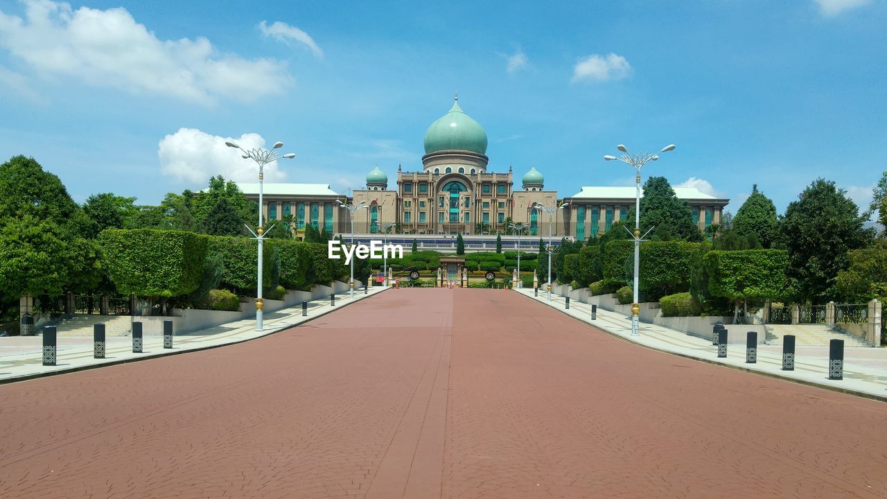 Pathway leading towards perdana putra against sky