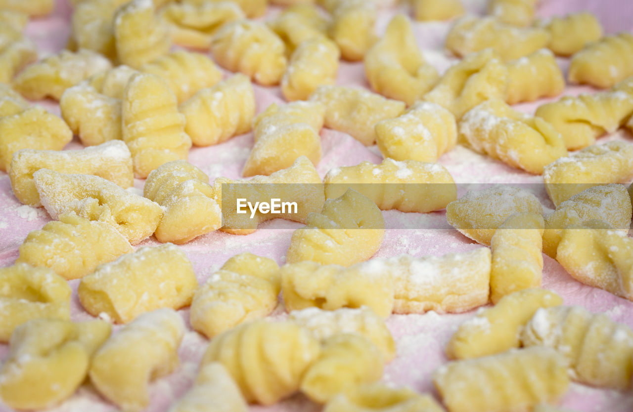 High angle close-up of gnocchi on cutting board