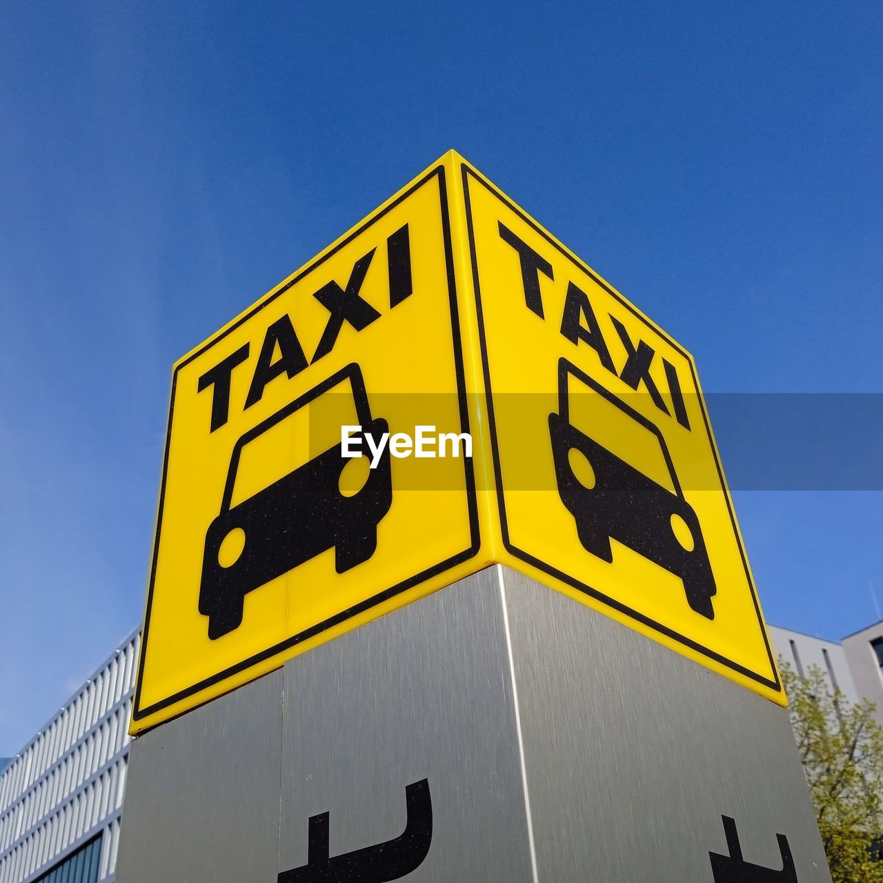 yellow, sign, communication, sky, traffic sign, blue, street sign, clear sky, no people, text, low angle view, signage, architecture, nature, transportation, road, day, road sign, advertising, outdoors, symbol